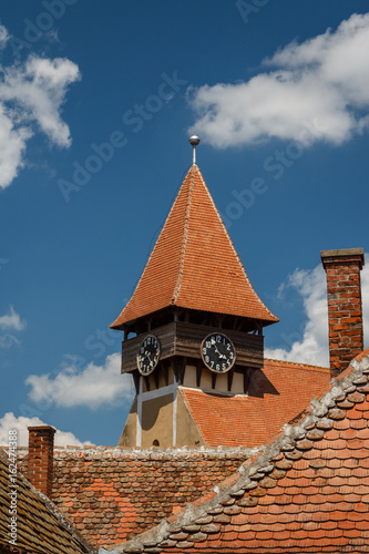Clock-tower of the fortified church in Miercurea Sibiului village, Romania photo