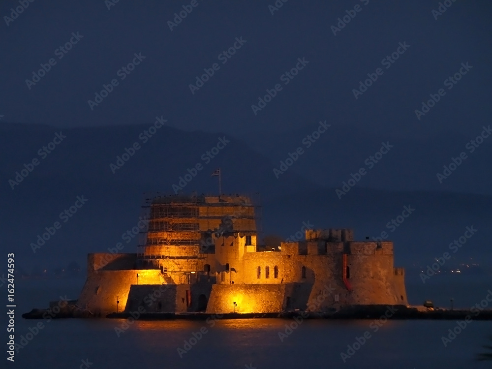 Light-up Bourtzi Castle at Night, the Medieval Fortress in the Middle of Nafplio Harbour, Nafplion, Greece Light-up Bourtzi Castle at Night, the Medieval Fortress in the Middle of Nafplio Harbour, Nafplion, Greece
