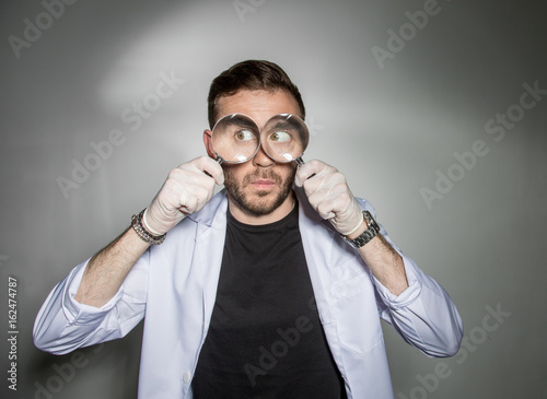 Chemist-a biologist looks through a magnifying glass