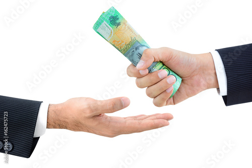 Hands of businessmen passing money, Australian dollars (AUD)