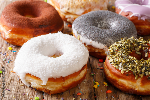 Delicious glazed multicolored donuts close-up. horizontal