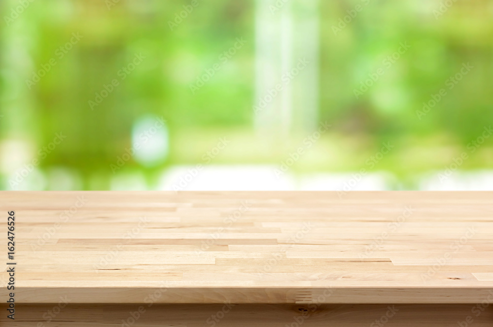 Wood table top on blur green background Wood table top on blur green background