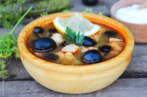 Billede på lærred Solyanka. Fish soup on a wooden table.