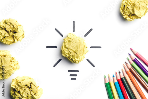 Crumpled yellow paper light bulb. Metaphor for good idea. Inspiration concept