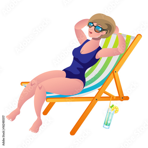 Young woman sunbathing lying on the beach in a deck-chair.