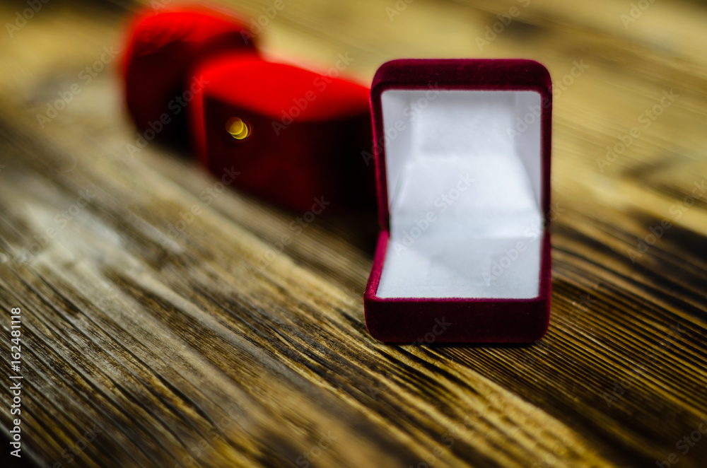 Different red jewelry boxes on wooden table Different red jewelry boxes on wooden table
