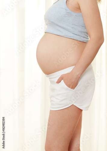 Pregnant woman showing her abdomen