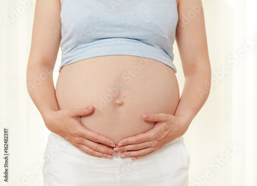 Pregnant woman showing her abdomen © goir