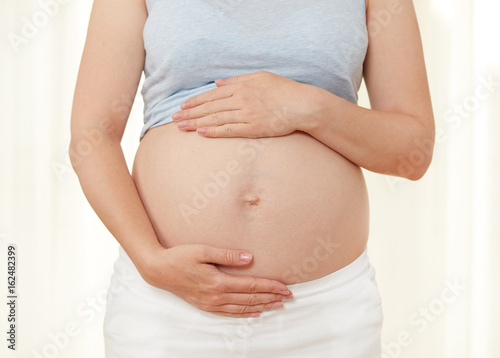 Pregnant woman showing her belly