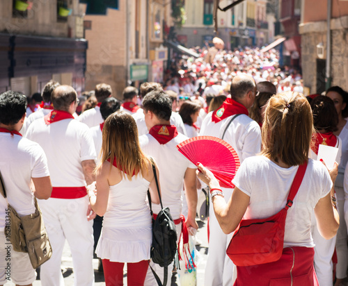 People celebrate San Fermin festival in traditional white abd red clothing with red necktie, 06 July 2016, Pamplona, Navarra, Spain. Crowd photo