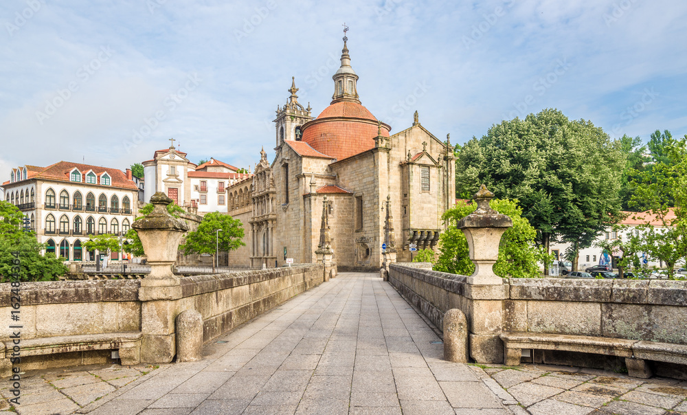 View at the Sao Goncalo monastery through the Old bridge over the river Tamega in Amarante ,Portugal - obrazy, fototapety, plakaty 