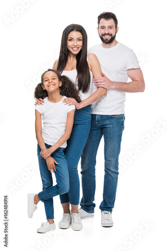 young multiethnic family in casual clothing looking at camera isolated on white
