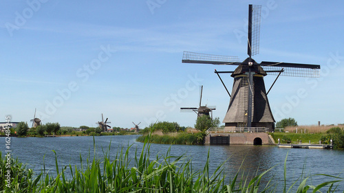 Row of mills in Kinderdijk, Netherlands. This cover nineteen mills in the northwest of the Alblasserwaard, in the Green Heart of Holland. Since 1997 they have been on UNESCO World Heritage List.