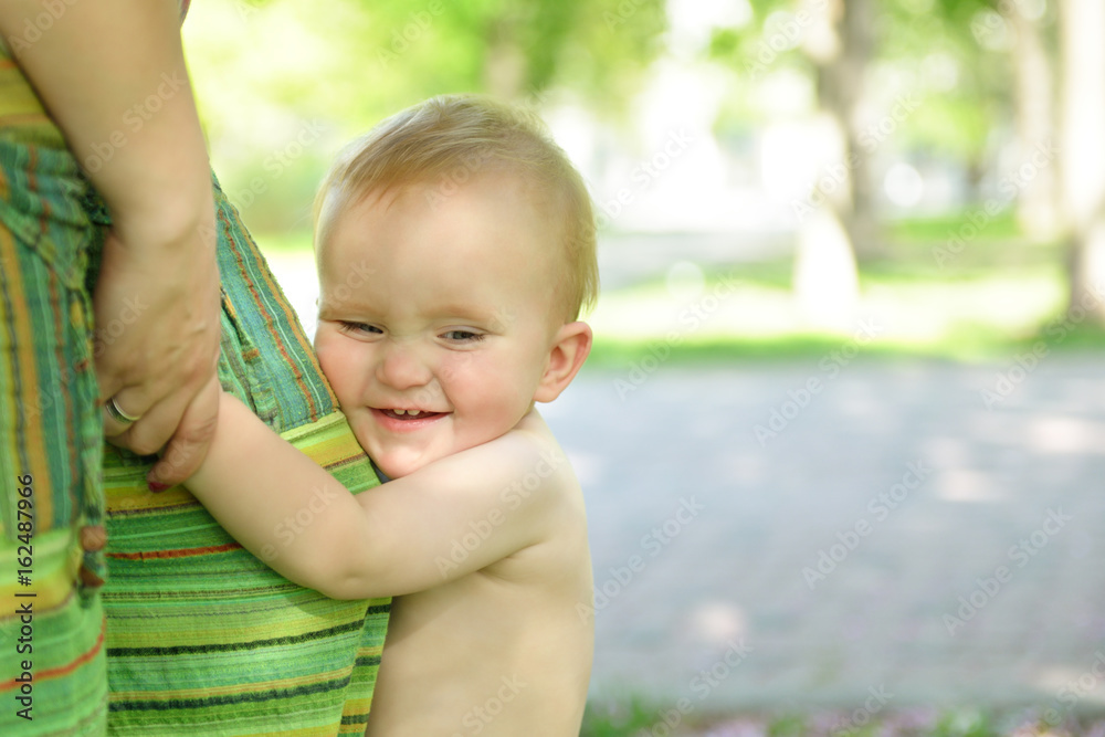 Happy mother holding her adorable little son. Family outdoor leisure. Little kid with his mom playing in park, image toned, soft focus Happy mother holding her adorable little son. Family outdoor leisure. Little kid with his mom playing in park, image toned, soft focus