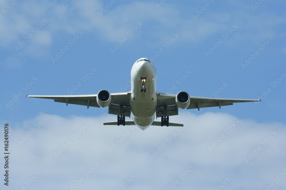 Passenger Airplane Landing with cloud and blue sky