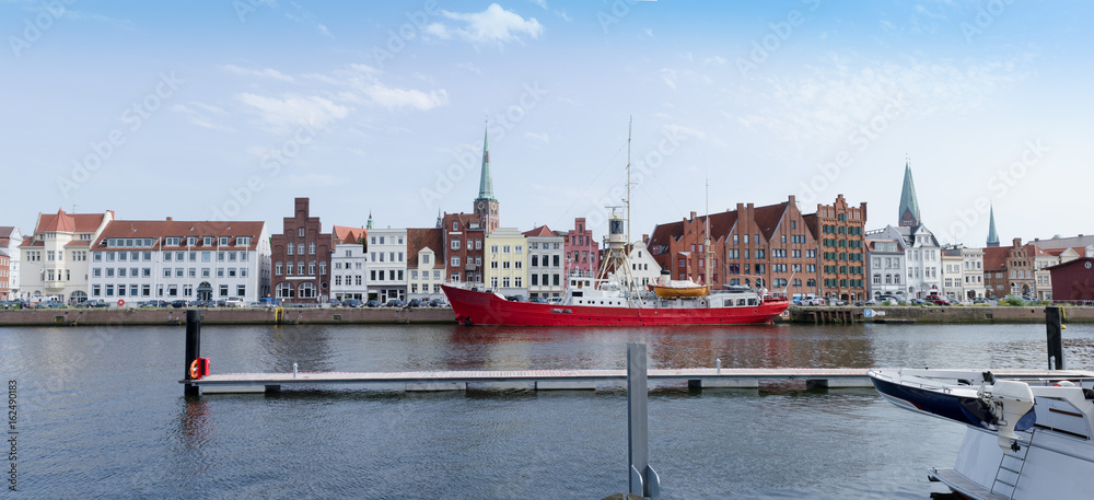 Lübeck, city view with historical facades on the untertrave Street with fire ship