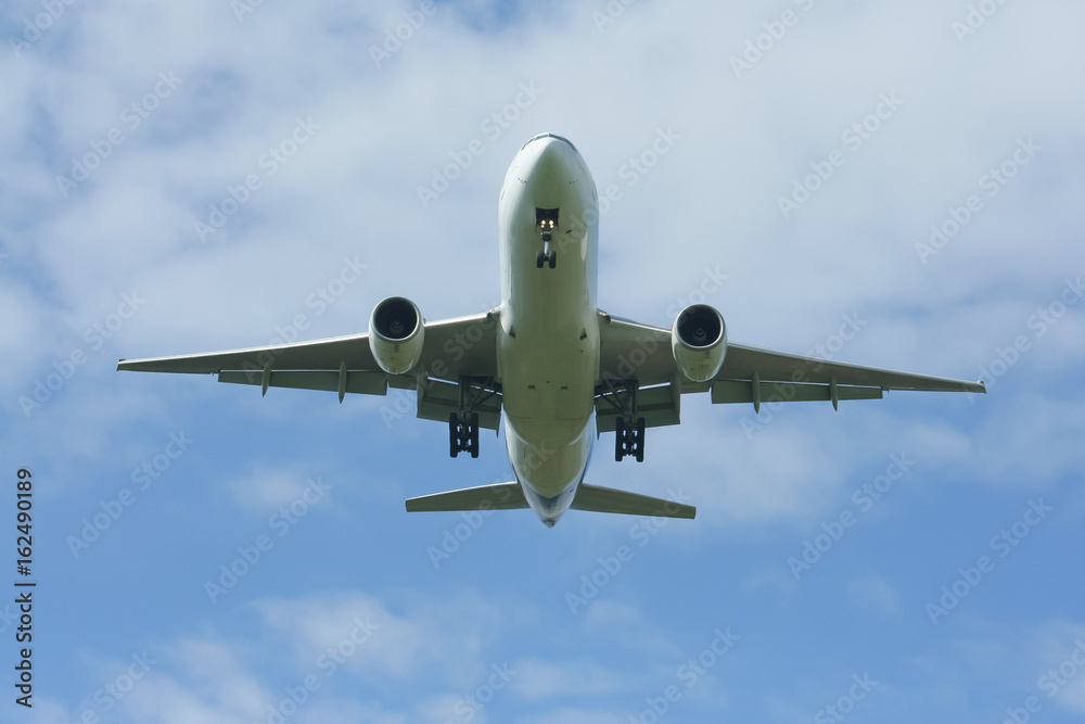 Passenger Airplane Landing with cloud and blue sky