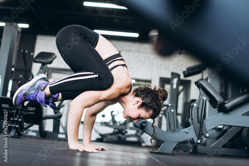 Flexible young woman train in the gym