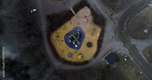 Kids playground, Cinema 4k rising aerial skreewdriver view above a child playground in fiskari steelworks, at a sunny spring evening, in Raasepori, Uusimaa, Finland