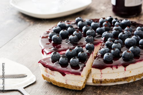 Blueberry cheesecake on wooden table
 photo