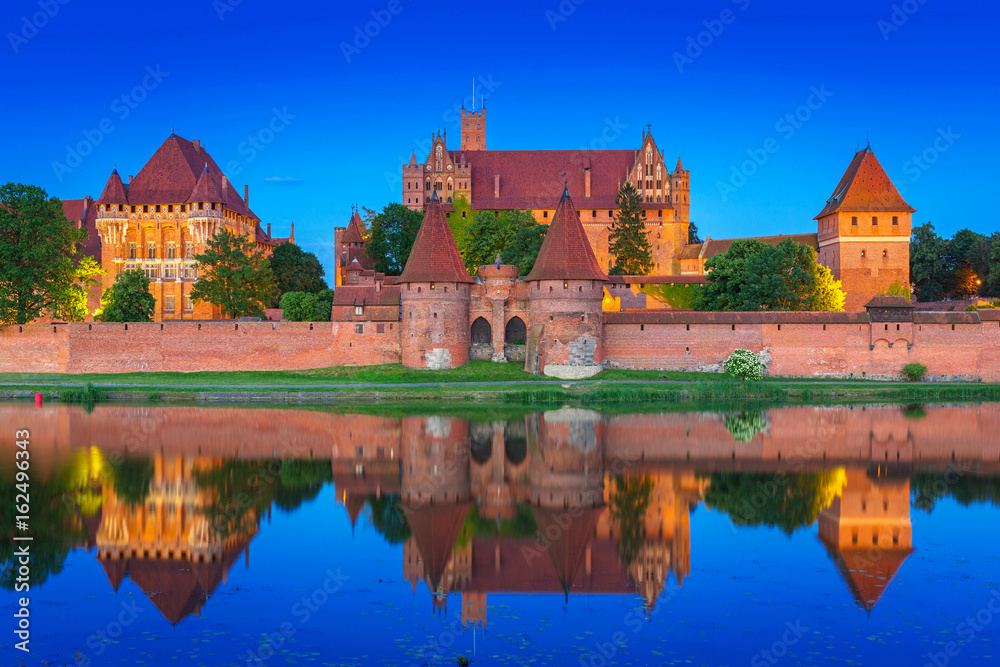 The Castle of the Teutonic Order in Malbork at dusk, Poland The Castle of the Teutonic Order in Malbork at dusk, Poland