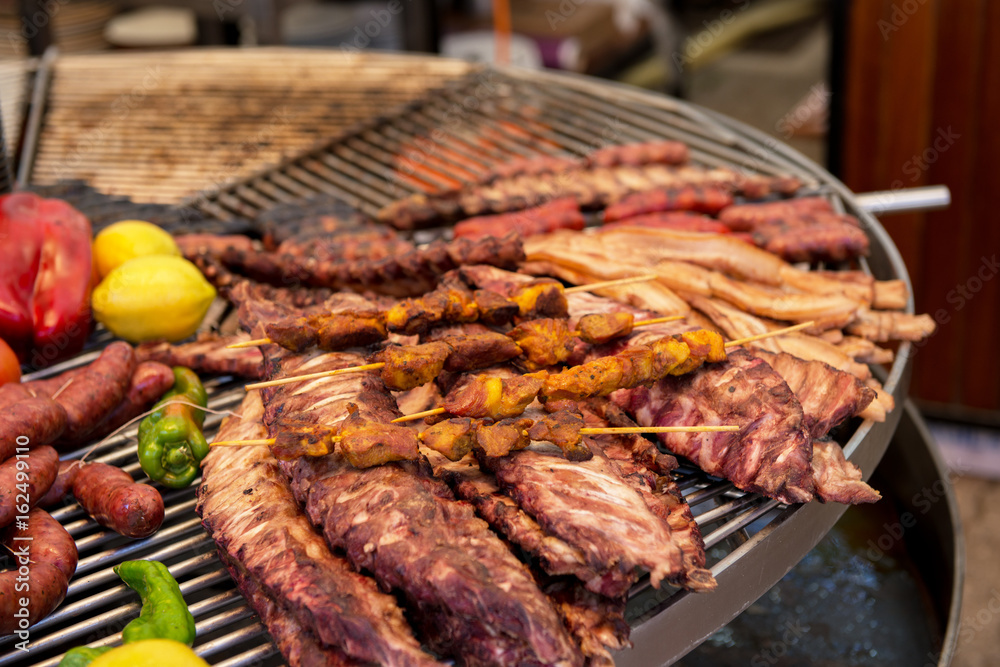 Street food in San Fermin feast, Pamlona, Navarra, Spain. Pork. Grilled meat. Spanish traditional cuisine. Spanish national dish.