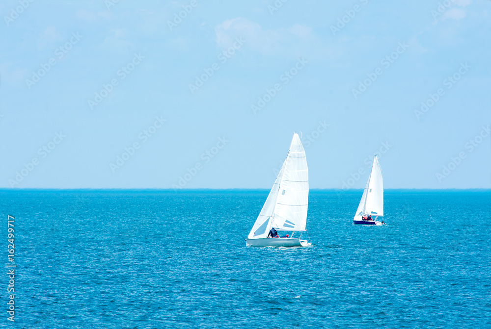 Sailing. Yachting. Tourism. Luxury Lifestyle. Ship yachts with white sails in the open sea.