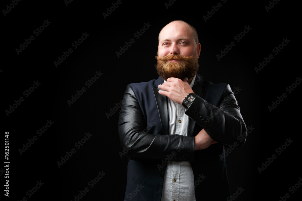 Pleased man stroking ginger beard