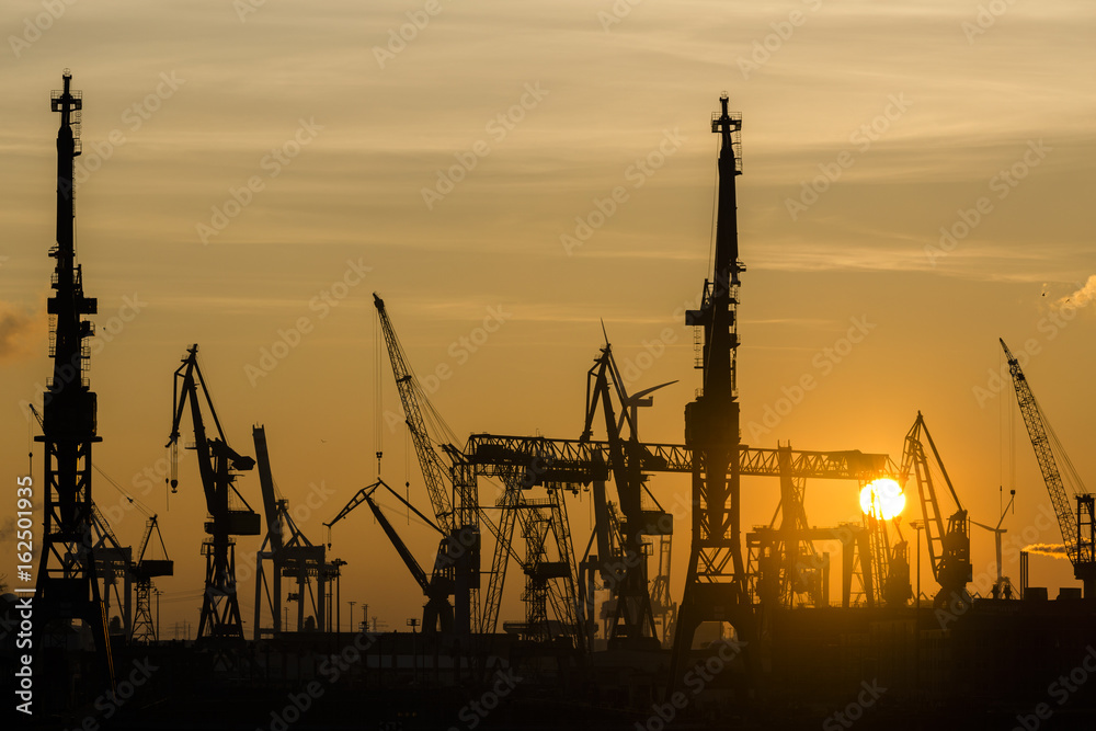 Silhouette of container harbor in Hamburg at sunset