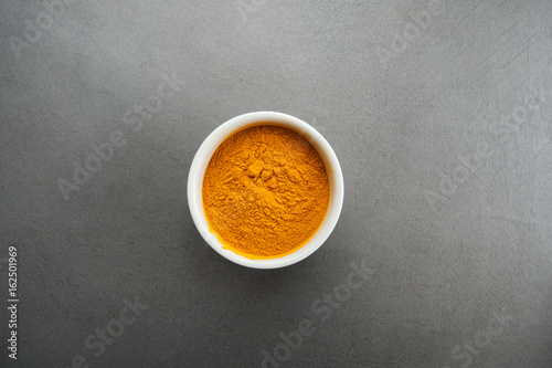 Photography Seasoning curry on a gray textured stone table..