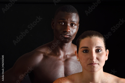 portrait of a couple mixed race on black
