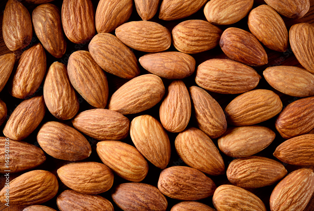 Peeled almonds closeup. Nuts background. Peeled almonds closeup. Nuts background.