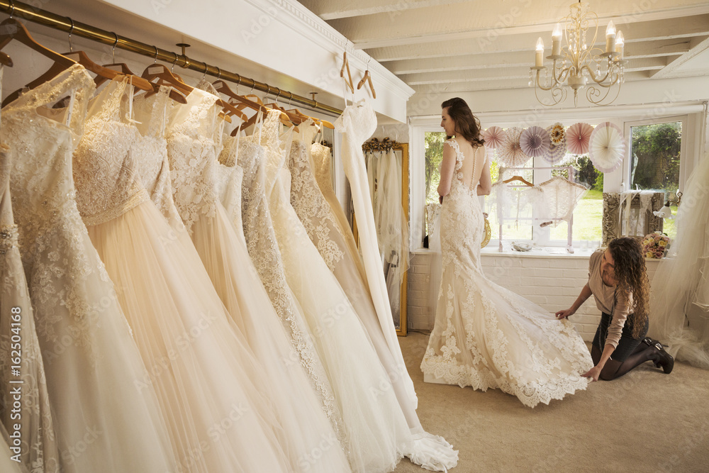 Rows of wedding dresses on display in specialist wedding dress shop Rows of wedding dresses on display in specialist wedding dress shop