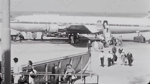 Switzerland, 1960s : People descend and climb from the Swiss airplane
