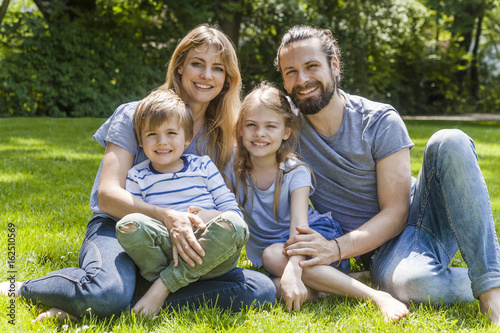 Wallpaper Mural Portrait of happy family sitting on meadow Torontodigital.ca