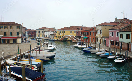 Channel with boats on the island of Murano near Venice, overcast © Lunnaya
