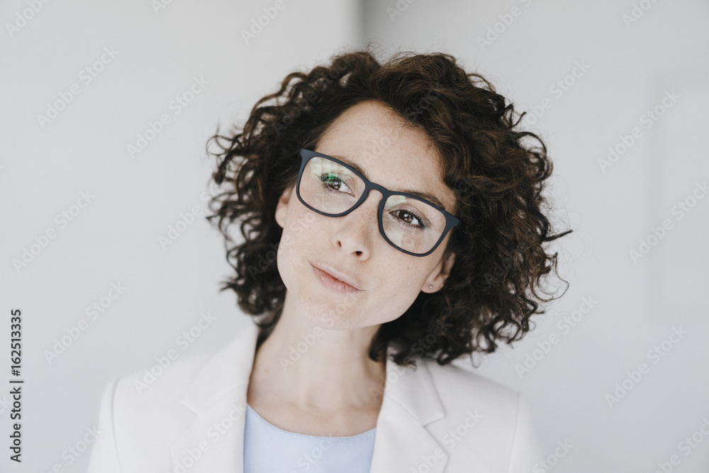 Businesswoman wearing glasses, looking doubtfully Businesswoman wearing glasses, looking doubtfully