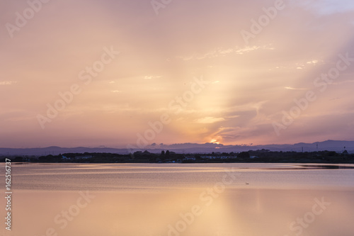 Pink orange and purple Carnon-Plage Montpellier sunset above water southern France