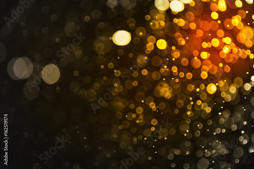 Abstract gold bokeh and black background, golden light Christmas