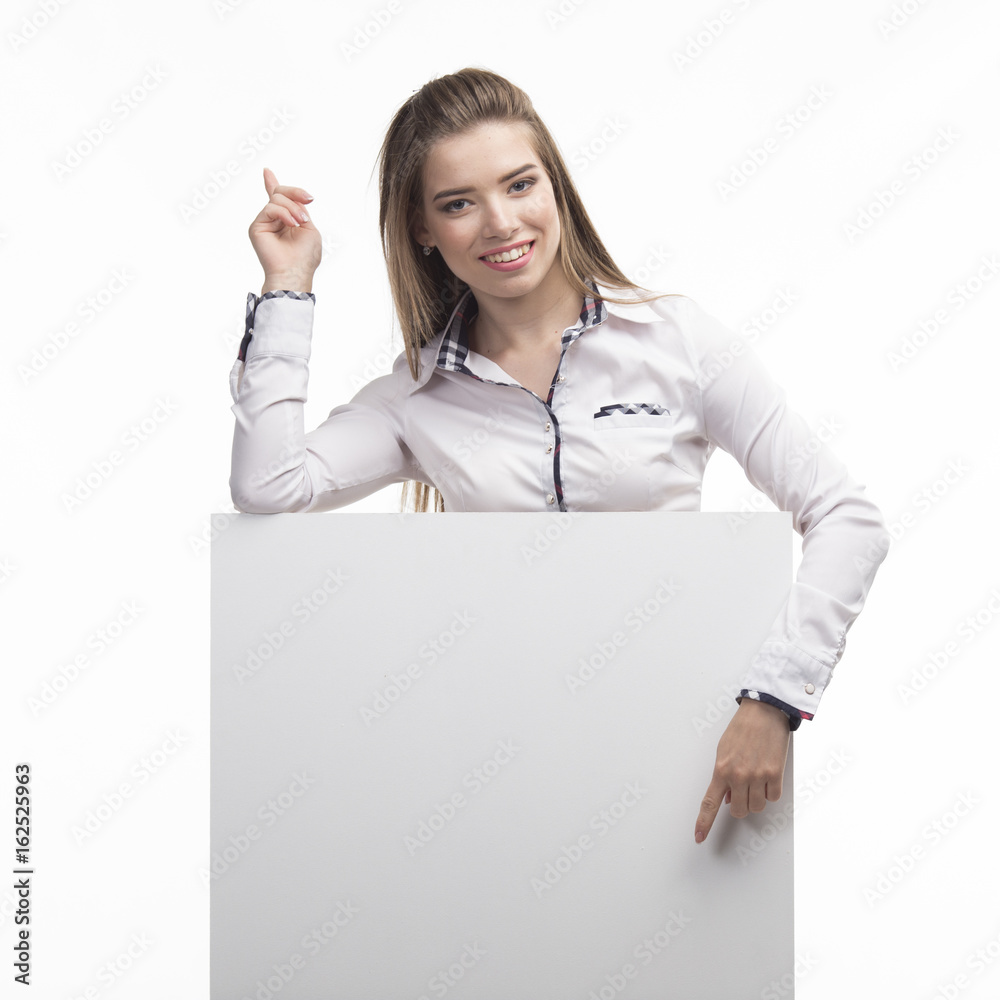 Young happy woman portrait of a confident businesswoman showing presentation, pointing placard gray background. Ideal for banners, registration forms, presentation, landings, presenting concept.. Young happy woman portrait of a confident businesswoman showing presentation, pointing placard gray background. Ideal for banners, registration forms, presentation, landings, presenting concept..