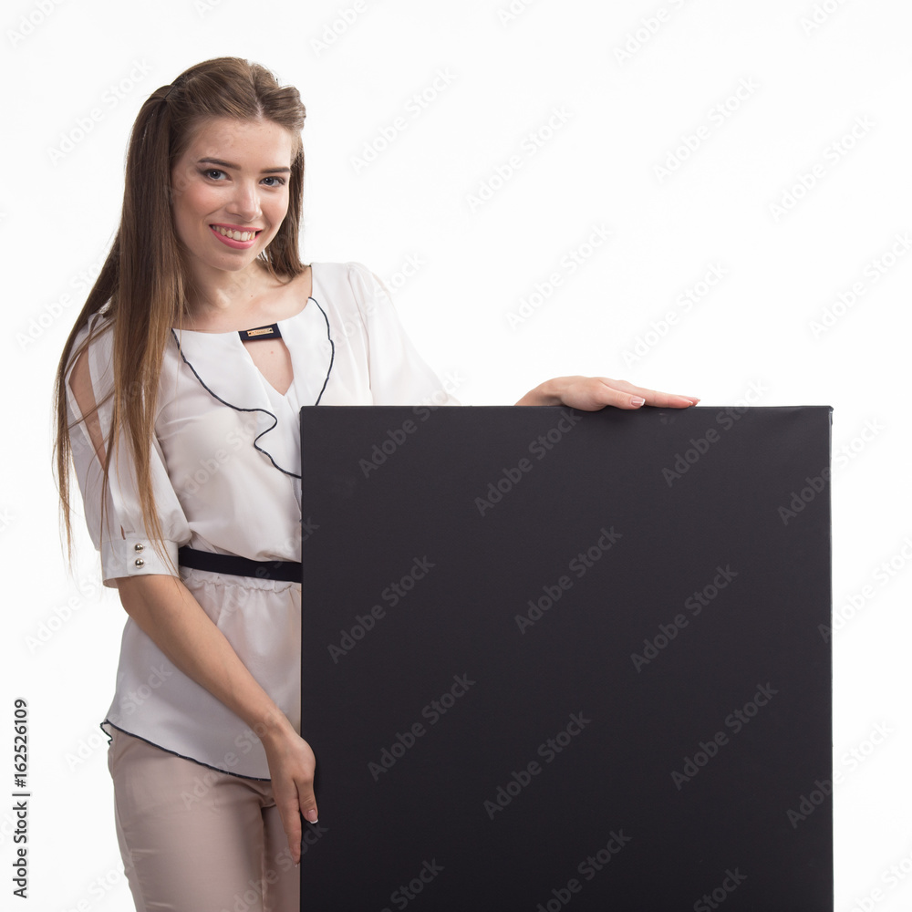 Young happy woman portrait of a confident businesswoman showing presentation, pointing placard black background. Ideal for banners, registration forms, presentation, landings, presenting concept.. Young happy woman portrait of a confident businesswoman showing presentation, pointing placard black background. Ideal for banners, registration forms, presentation, landings, presenting concept..