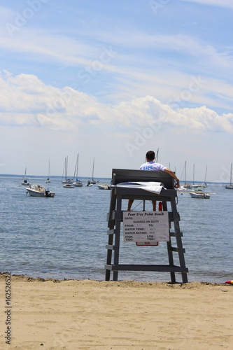 lifeguard on his chair looking out to sea © Andrew