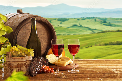 Fototapeta Naklejka Na Ścianę i Meble -  red wine bottle and wine glasses with wodden barrel