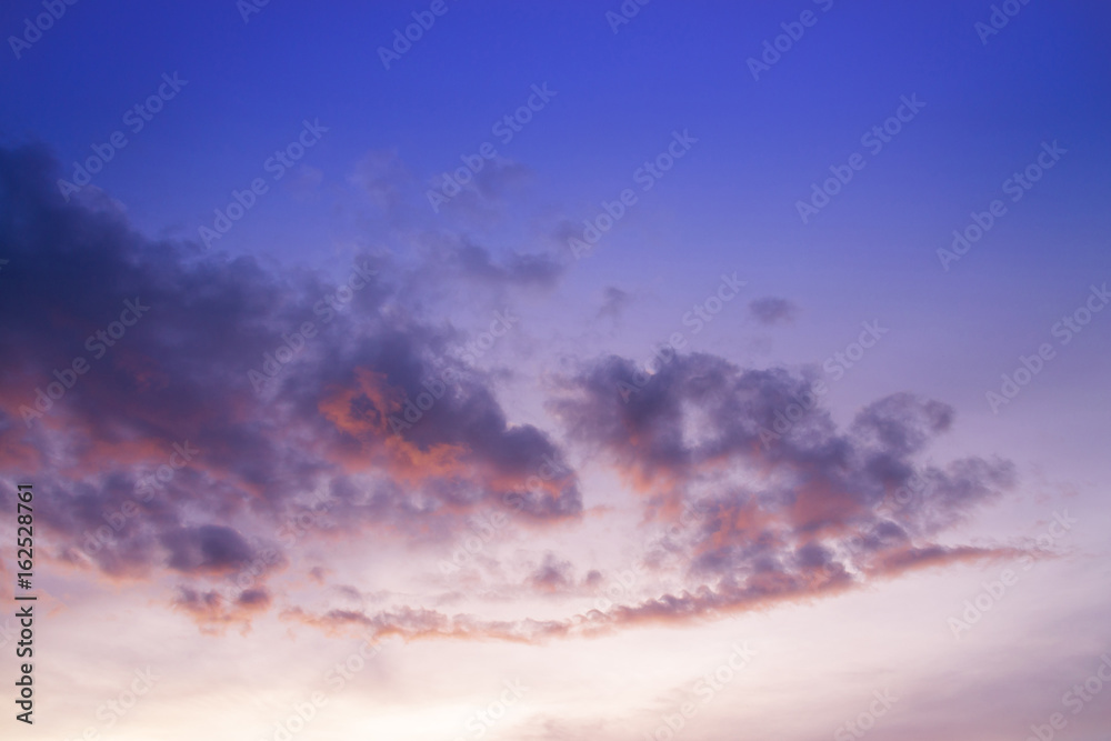 sunset / sun rise sky with rays of yellow and red light shining clouds and sky background and texture