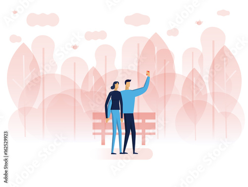 A man and woman are taking selfie photos.