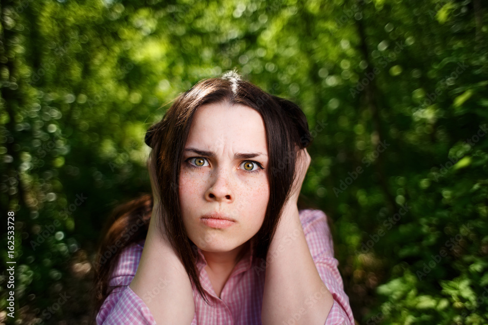Young woman closing ears. Ugly noise concept Young woman closing ears. Ugly noise concept