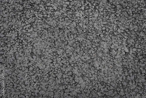 Dark grey asphalt background texture close up