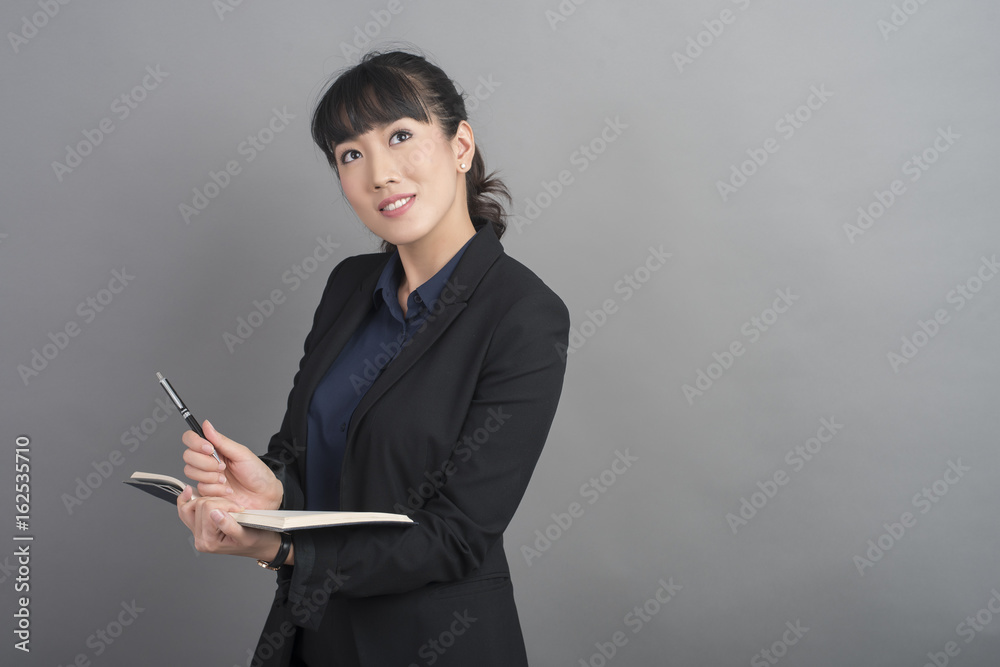 Beautiful Business Woman thinking on grey background Beautiful Business Woman thinking on grey background