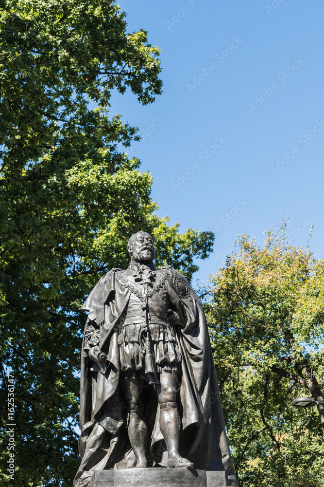 Hobart, Australia - March 19. 2017: Tasmania. Closeup of bronze statue of King Edward VII shows him looking proudly and defiant. Green park background and blue sky.