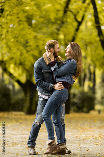 Smiling couple hugging in autumn park